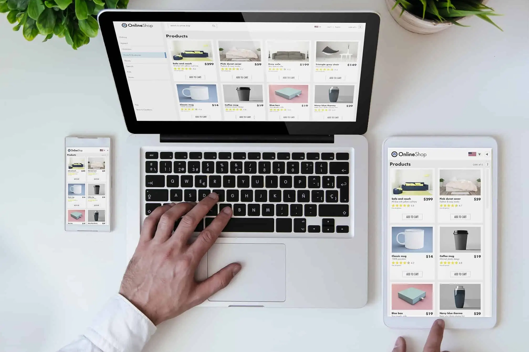 A person using a laptop and tablet for online shopping at a workspace.