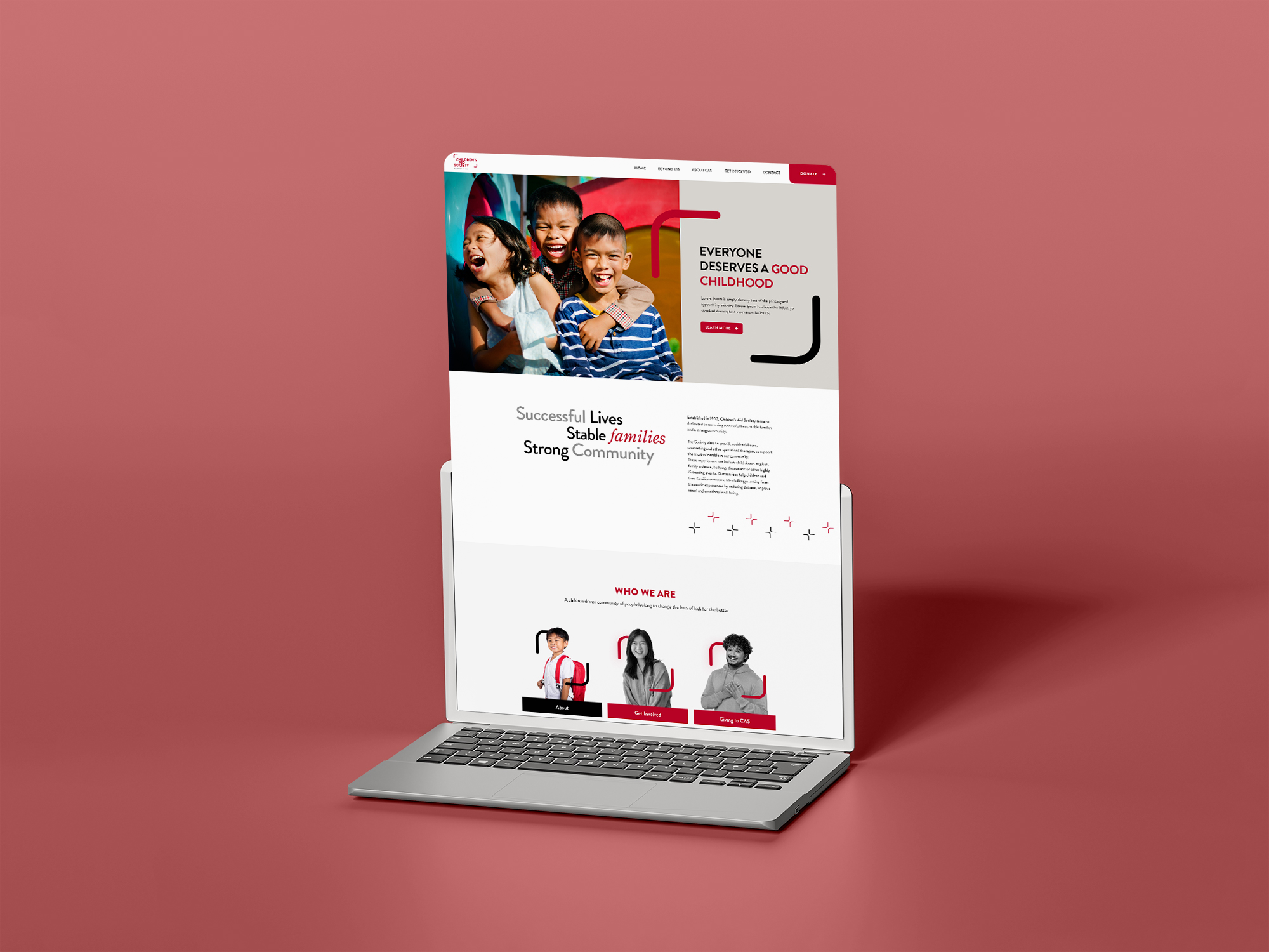 Laptop displaying vibrant website design on a red background.